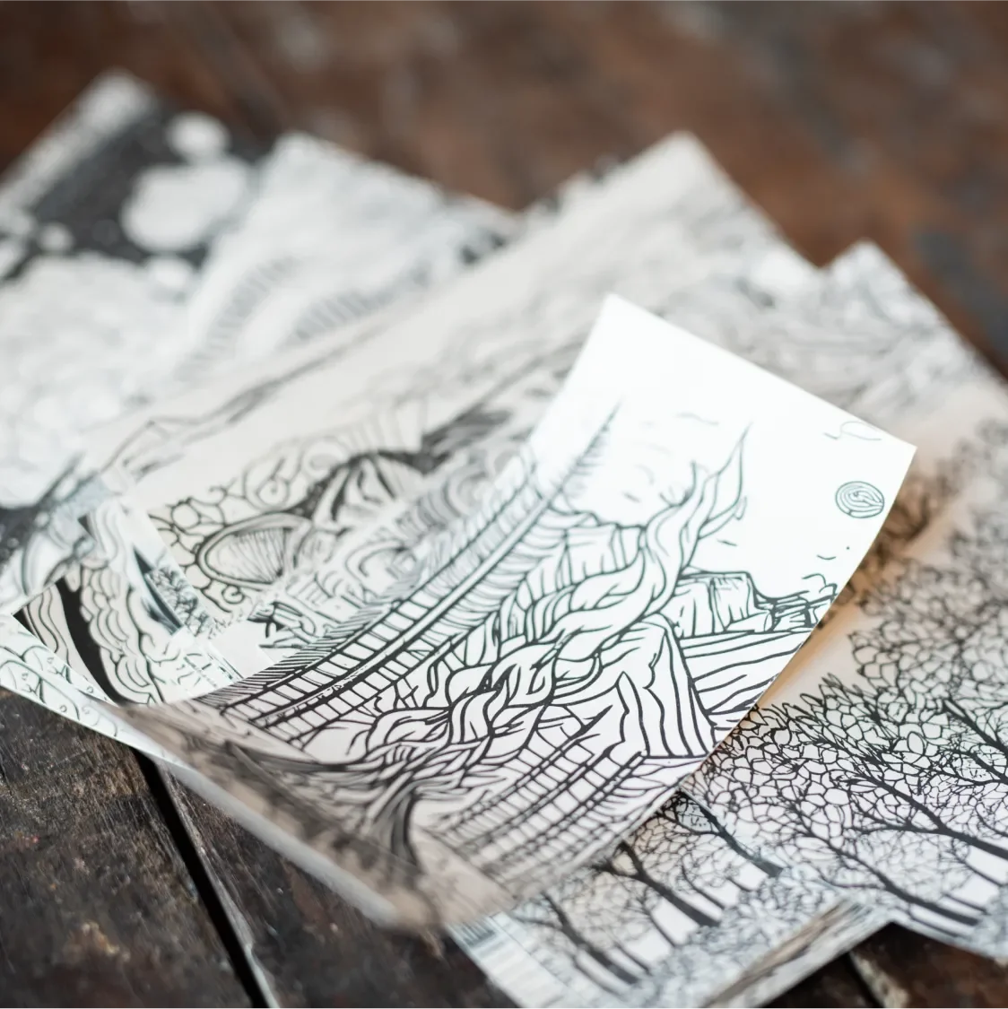 Coloring book pages in a stack featuring the bonfire page on top