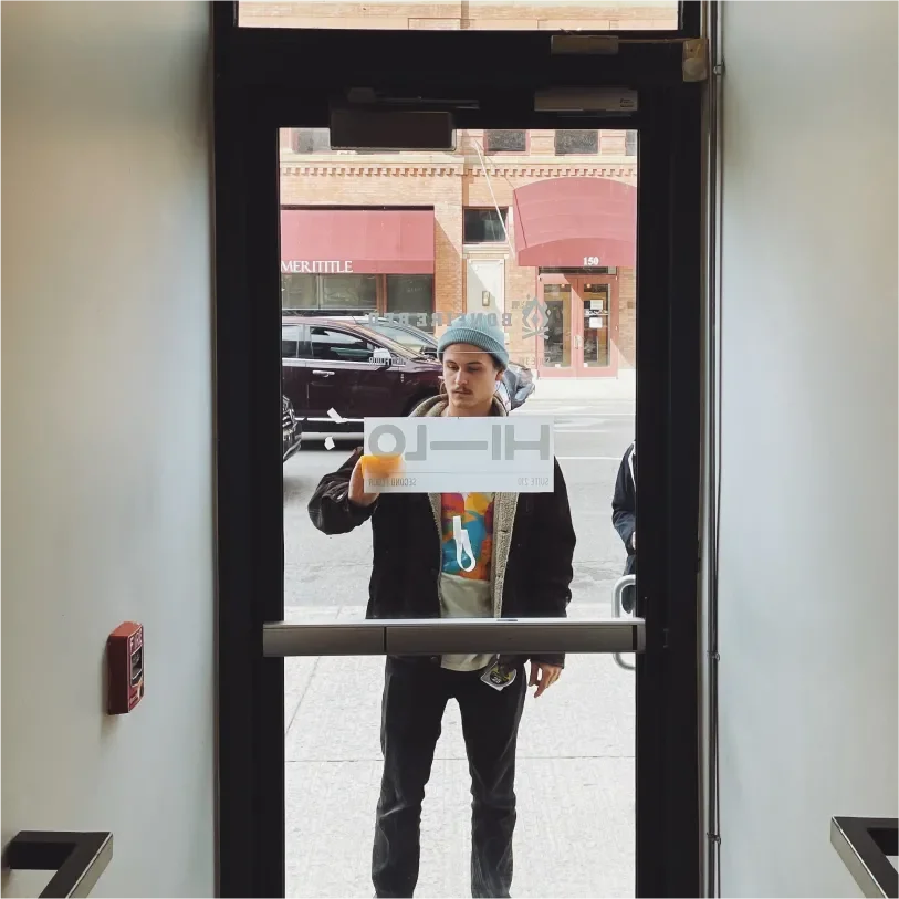 Hi-Lo door sign being applied by Logan Fischer