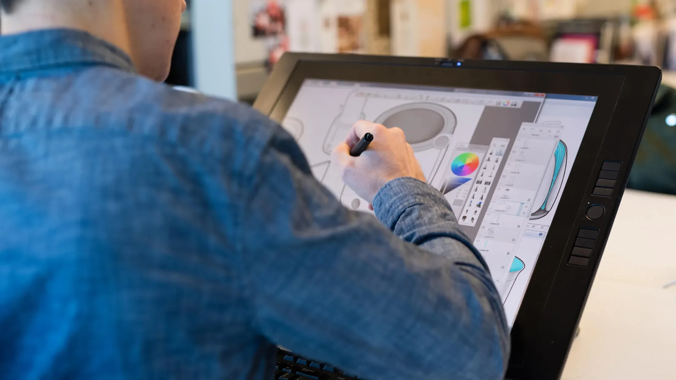 A person drawing on a graphics tablet